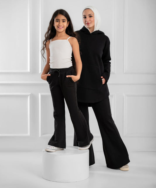 Akira The Weekend Flare Sweatpants in cozy fabric, with a relaxed fit and stylish flare leg design, shown on a model.