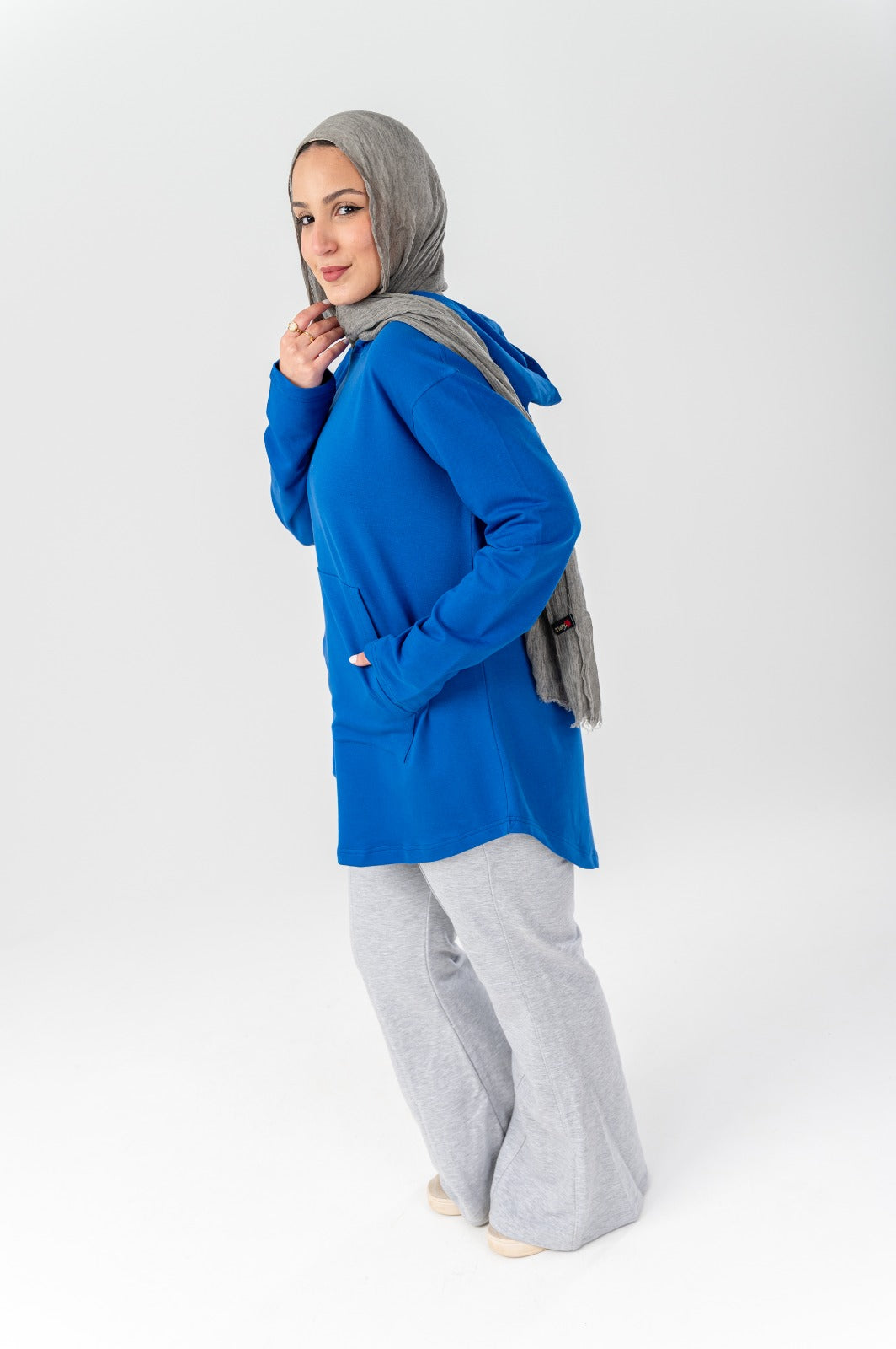 Blue hoodie by Akira, casual sweatshirt with front pocket and hood, shown on a white background.