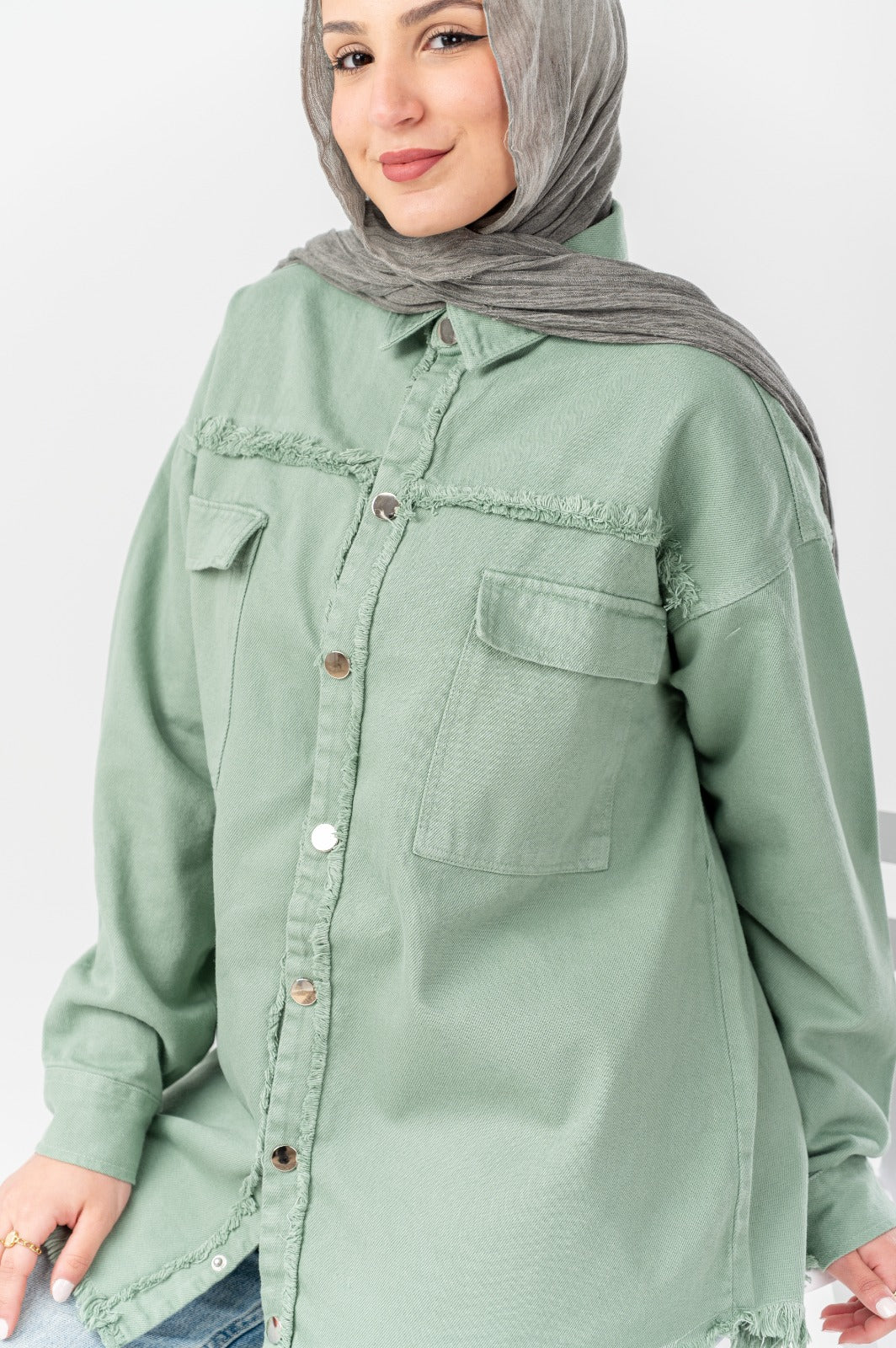 Distressed denim shirt by Akira featuring a casual fit, faded wash, and ripped details, displayed on a white background.