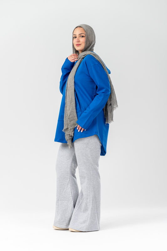 Blue hoodie by Akira featuring a relaxed fit, soft fabric, and a front pocket, displayed on a hanger.