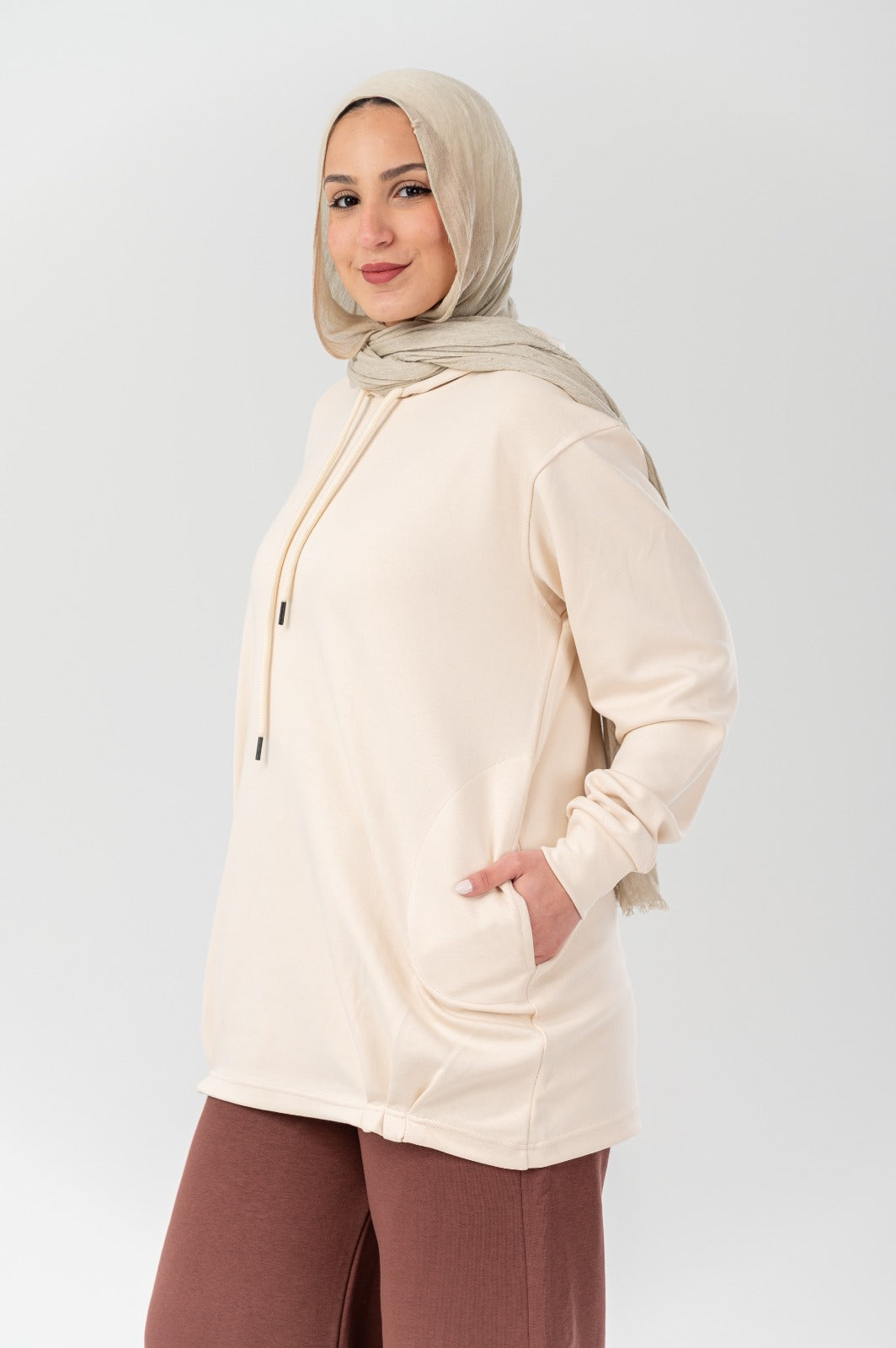 Beige Akira comfort hoodie with a relaxed fit, featuring a drawstring hood and soft fabric, ideal for casual wear.