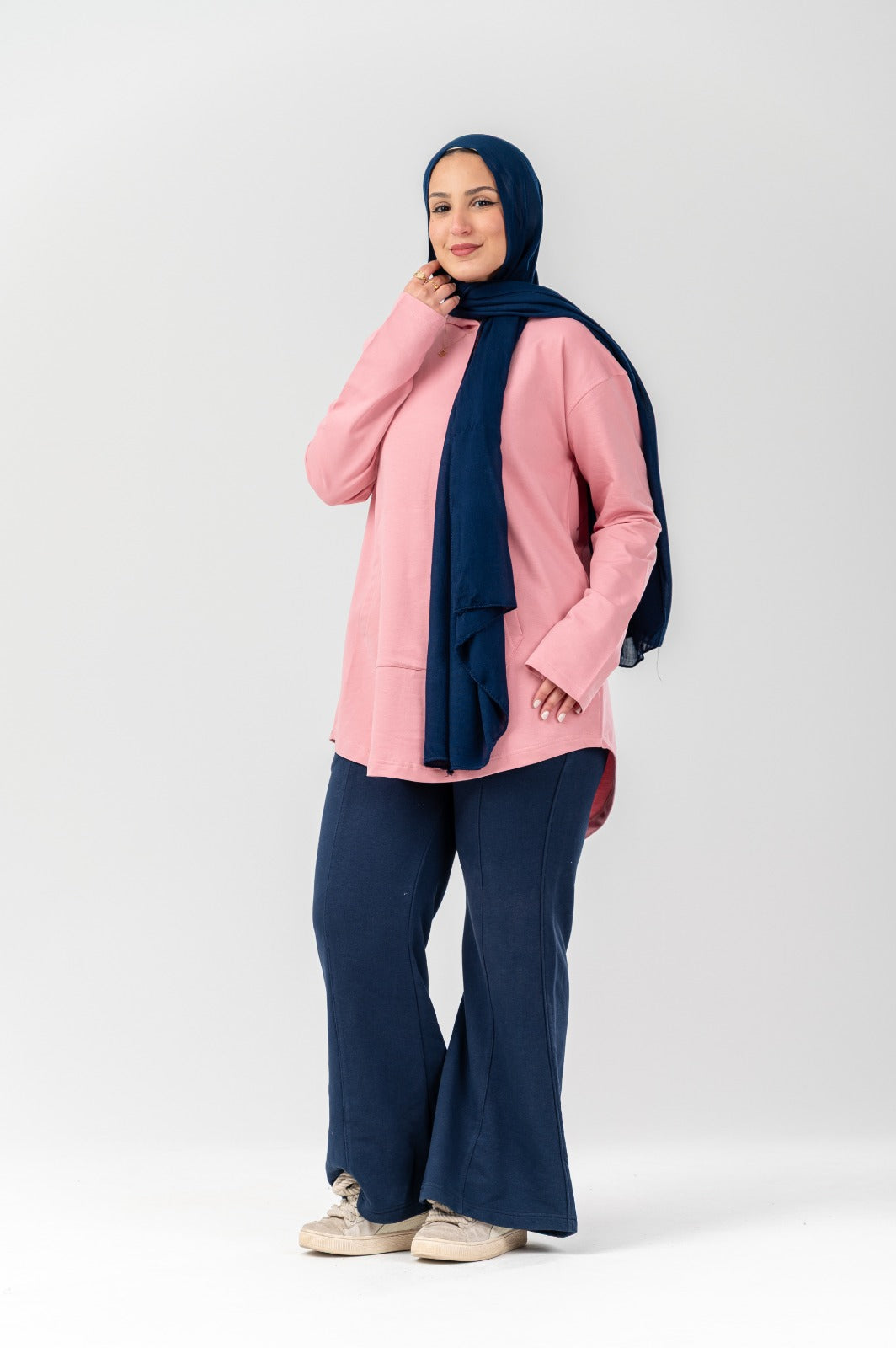 Pink Akira hoodie with front pocket and hood, casual streetwear style, soft fabric, displayed on a hanger.