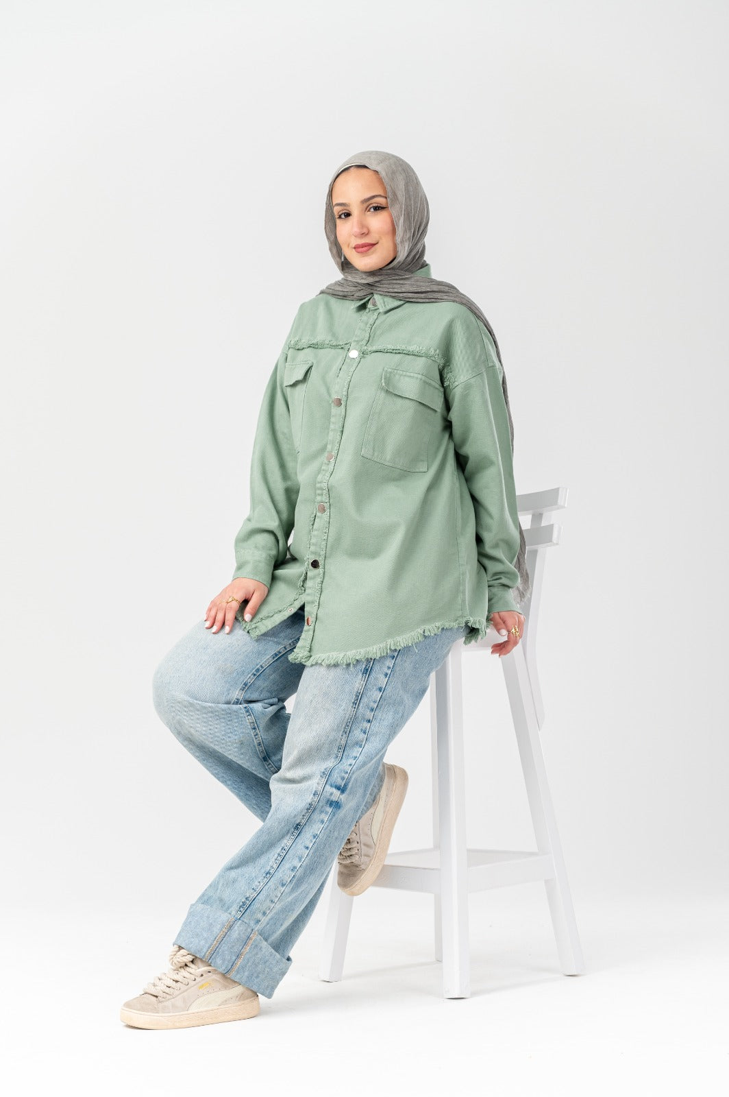 Akira distressed denim shirt with a casual fit, featuring frayed details and a classic button-up design.