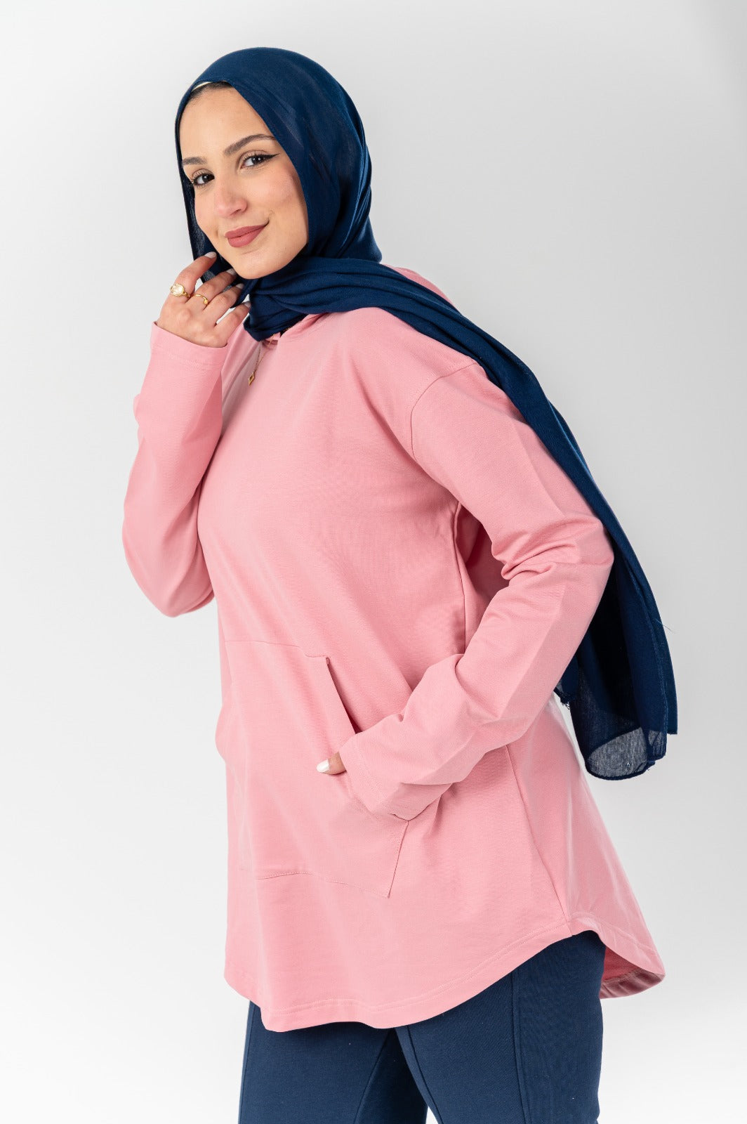 Pink hoodie by Akira featuring a soft fabric and relaxed fit, shown on a hanger with a casual style.