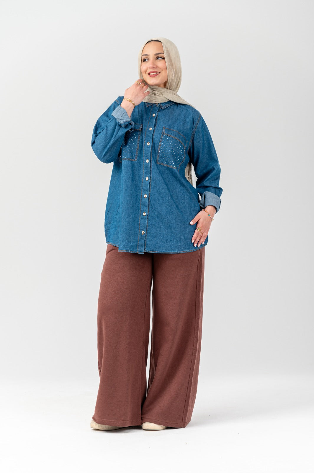 Akira Crystal-Pocket Denim Shacket featuring distressed denim, crystal-embellished pockets, and a relaxed casual fit.