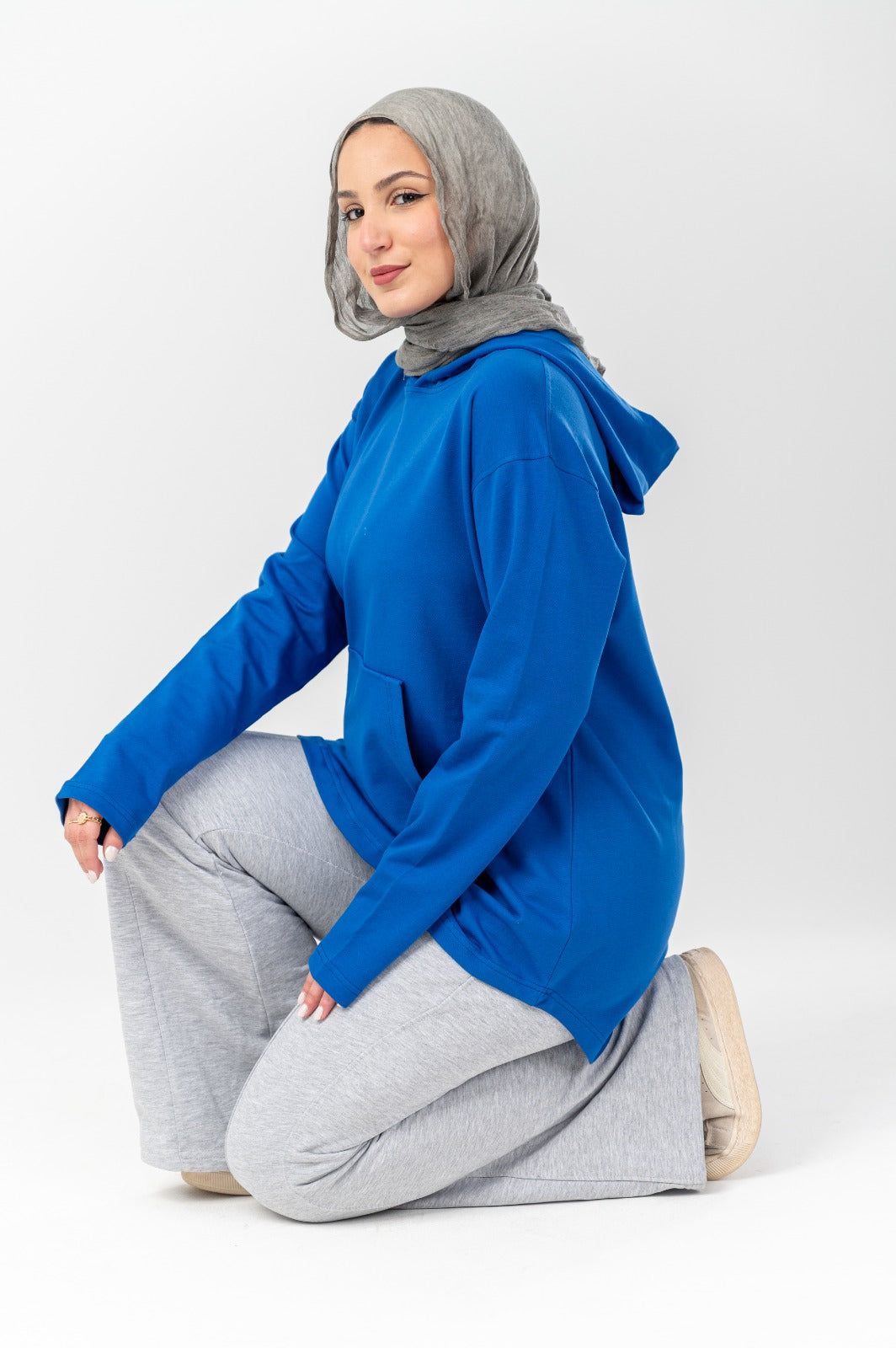 Blue hoodie by Akira featuring a front pocket and adjustable drawstrings, made from soft, comfortable fabric.