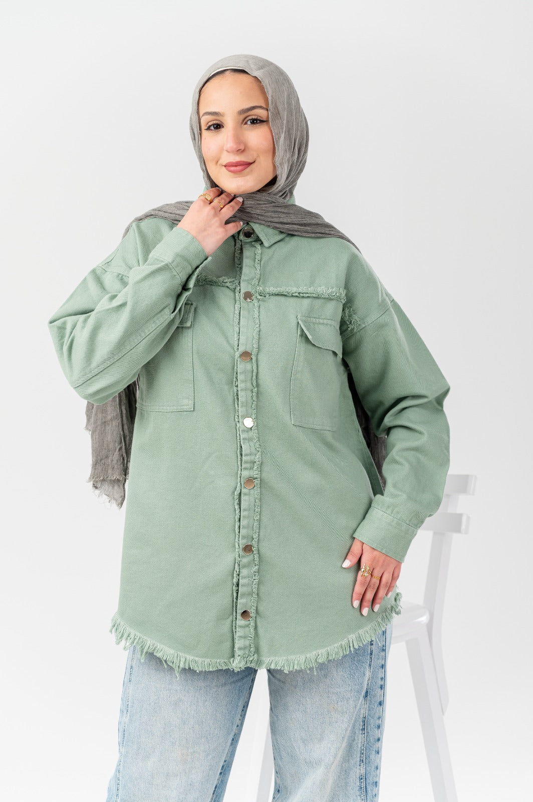 Akira distressed denim shirt with frayed details and classic fit, shown laid flat on a neutral background.