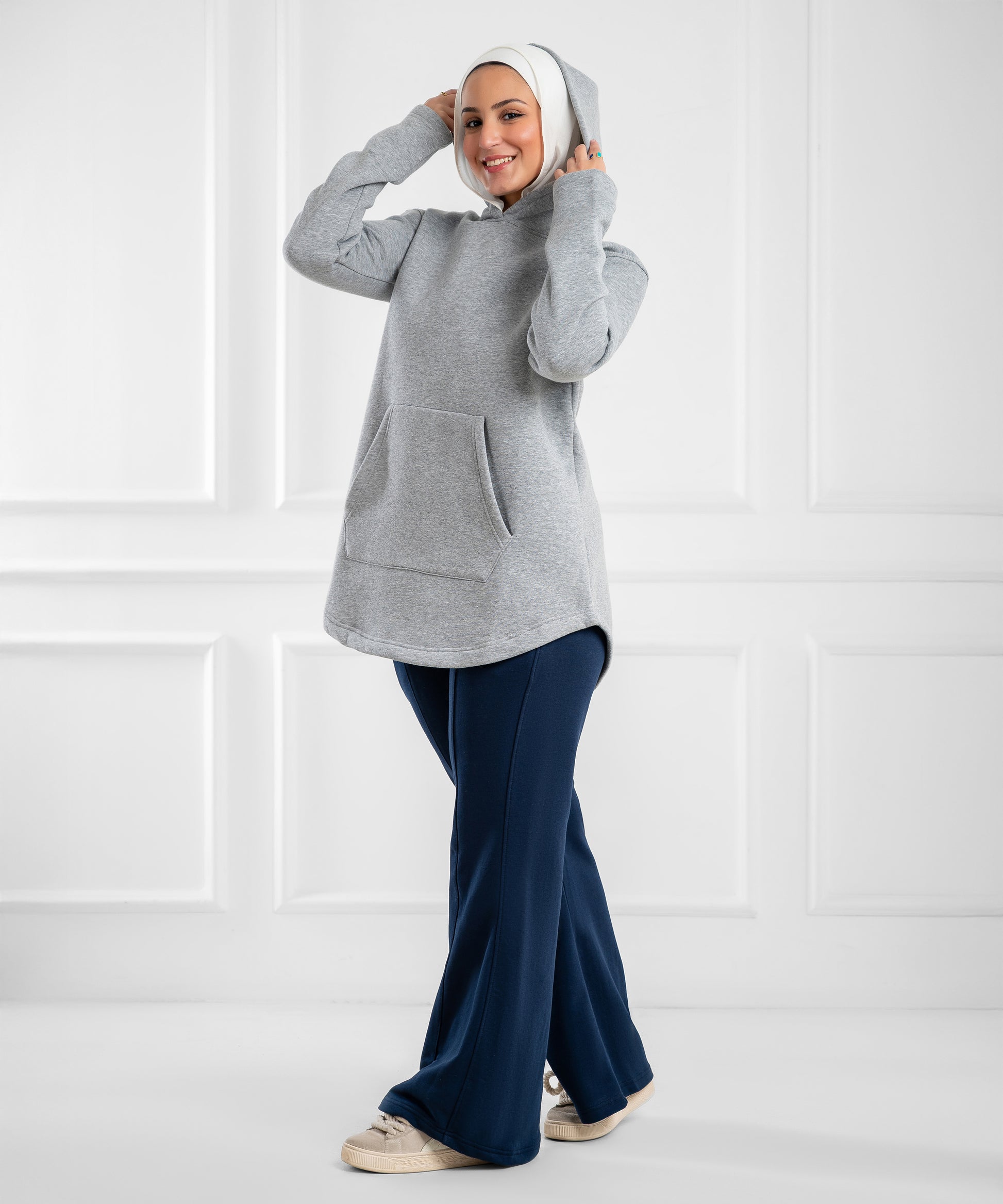 Akira curved-hem fleece tunic hoodie displayed on a hanger, featuring a cozy design and casual style.