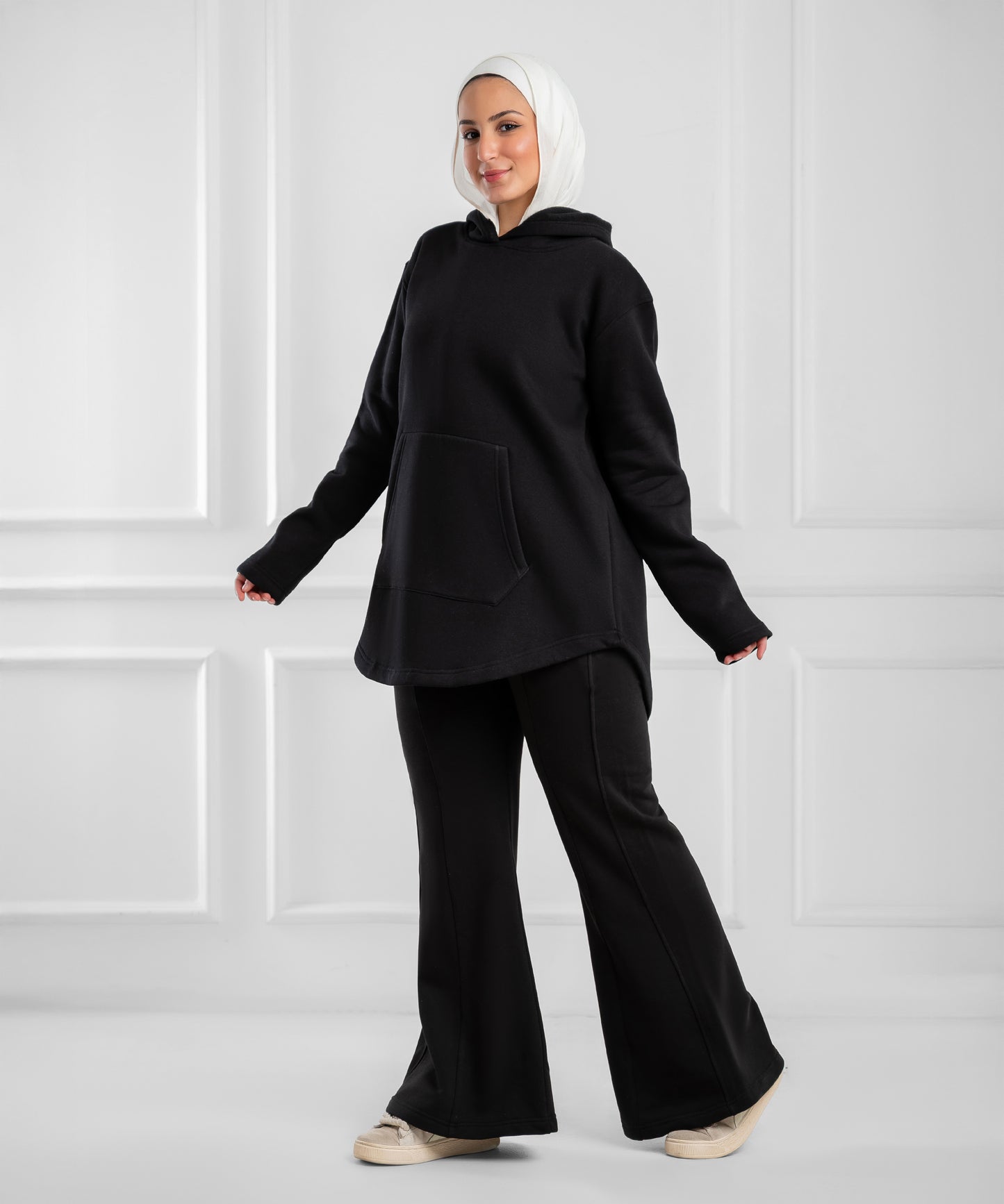 Soft gray Akira curved-hem fleece tunic hoodie displayed on a hanger showing its relaxed fit and cozy fabric.