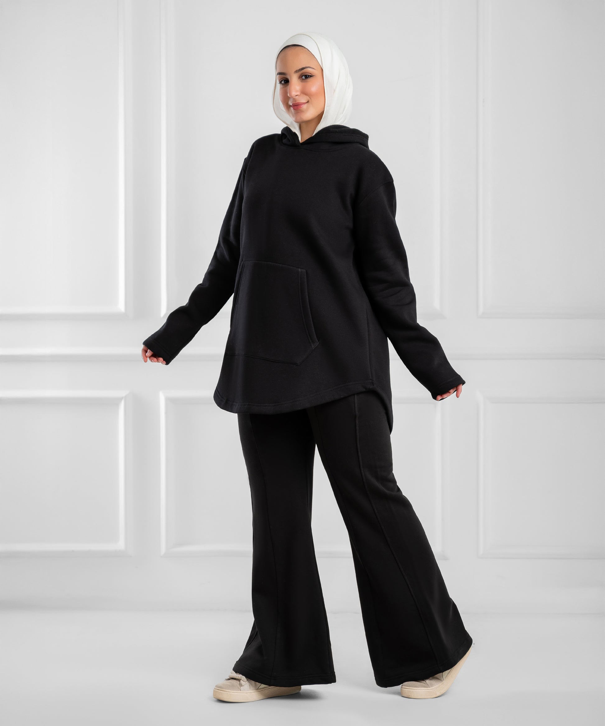 Soft gray Akira curved-hem fleece tunic hoodie displayed on a hanger showing its relaxed fit and cozy fabric.