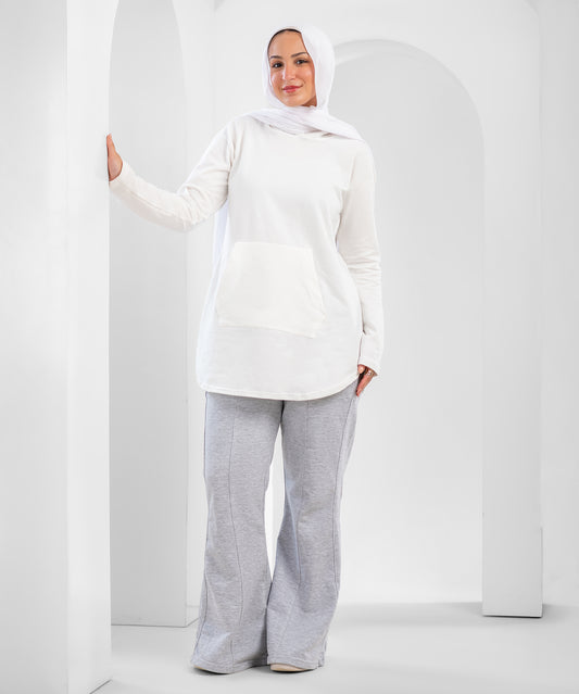 Akira pin tuck flare sweatpants with tapered legs and high-rise waist, shown on a hanger with a neutral background.