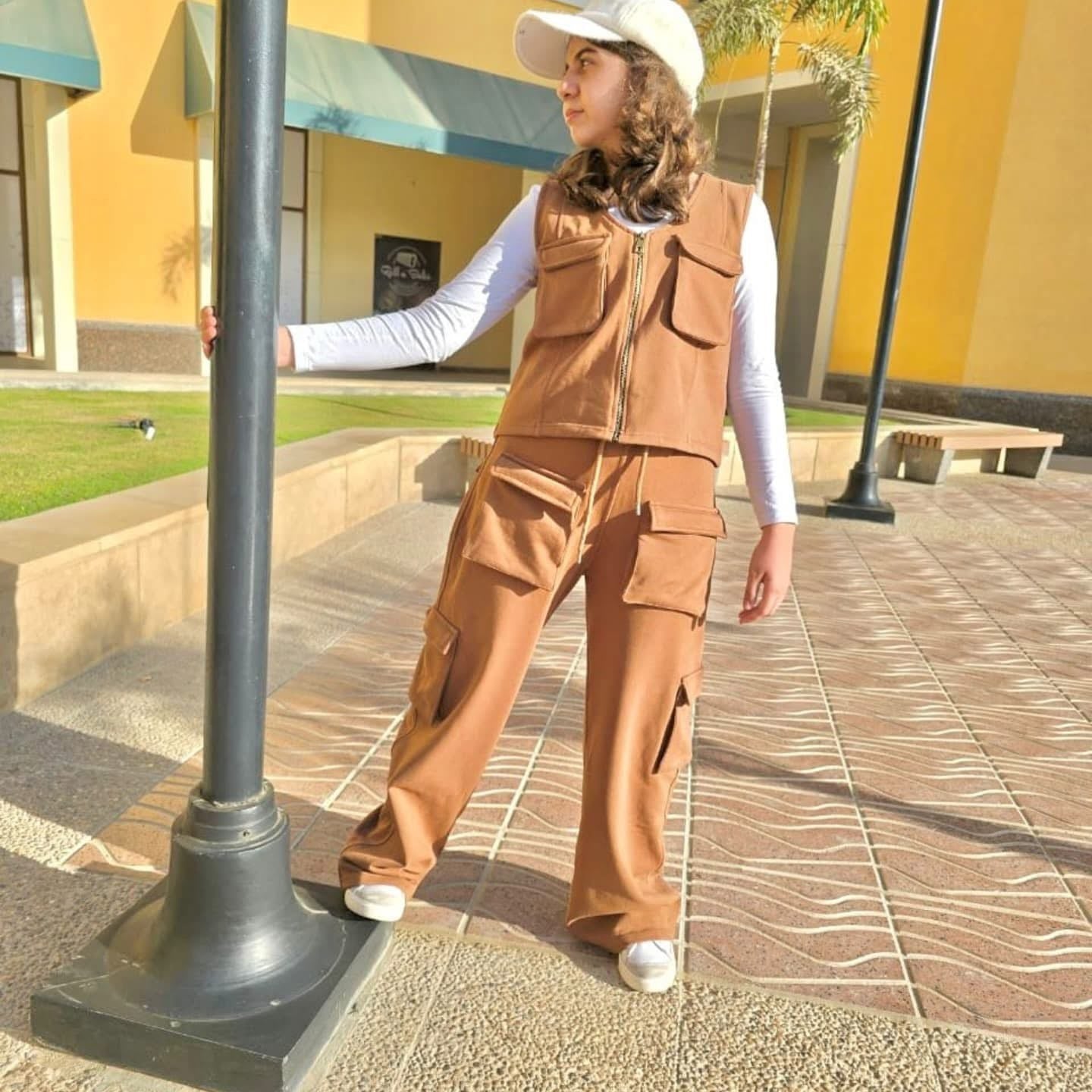 Akira cargo set featuring multiple pockets and adjustable straps, displayed laid out on a neutral background.