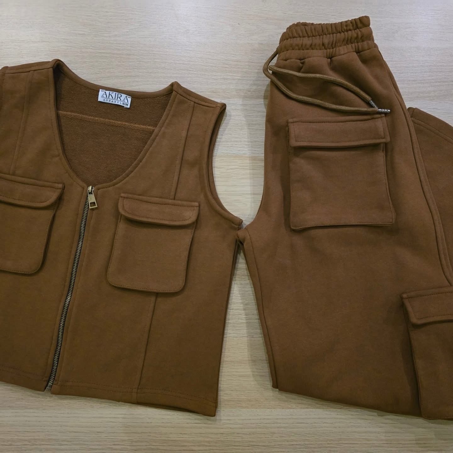 Akira cargo set featuring multiple pockets and adjustable waistbands, shown laid out on a flat surface.