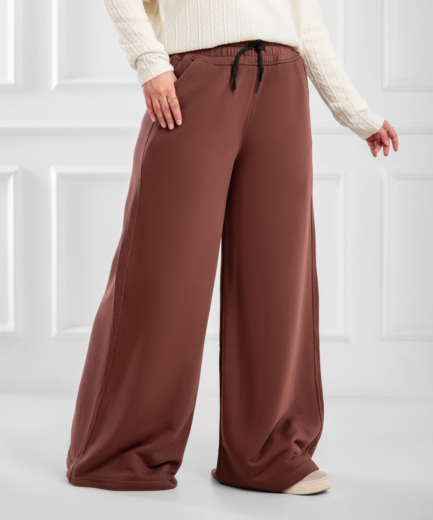 Akira wide-leg drawstring sweatpants shown on a model, featuring a relaxed fit and casual style.