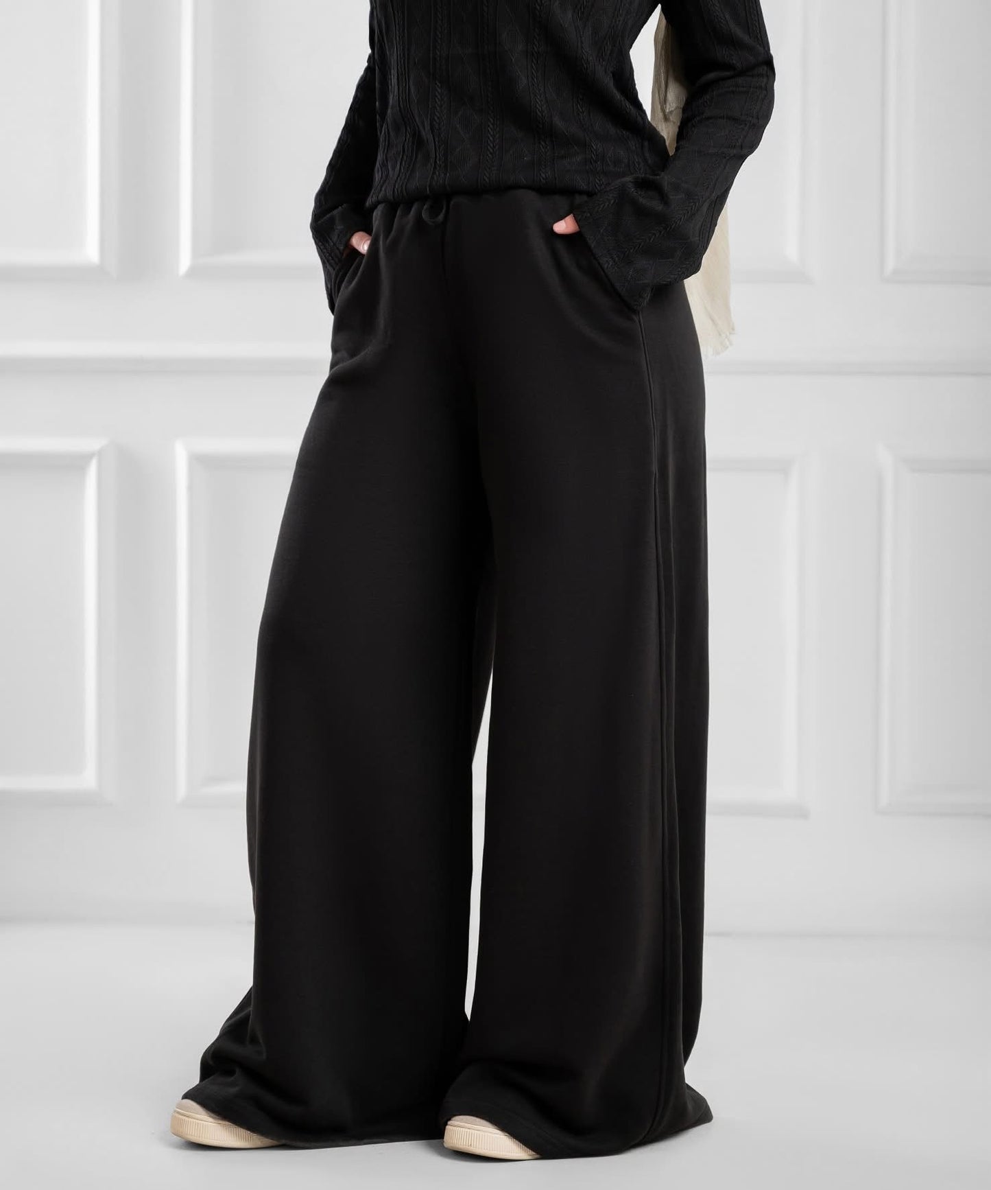 Akira wide-leg drawstring sweatpants displayed on a hanger, showcasing their relaxed fit and comfortable design.