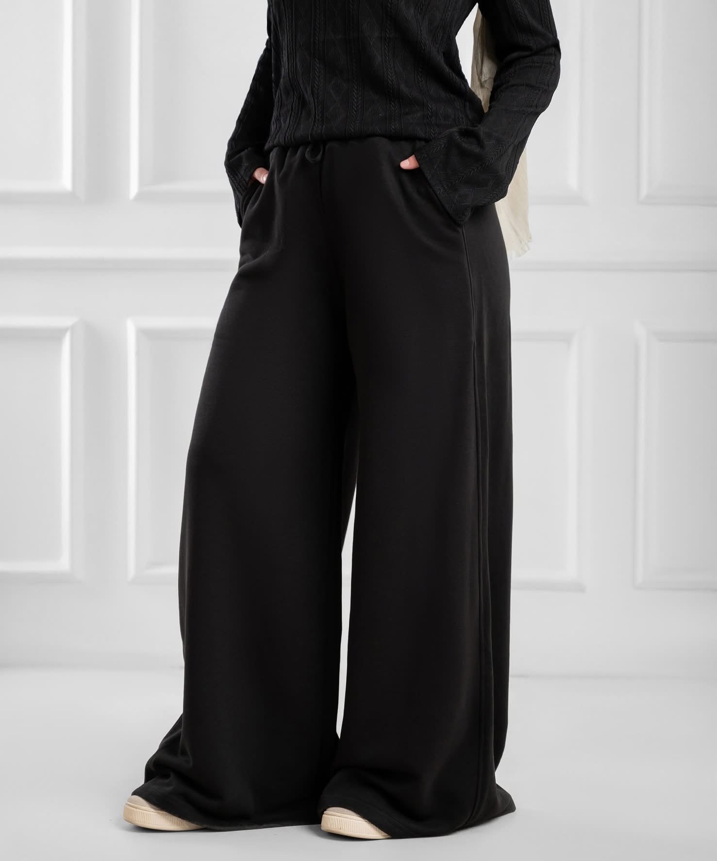 Akira wide-leg drawstring sweatpants displayed on a hanger, showcasing their relaxed fit and comfortable design.