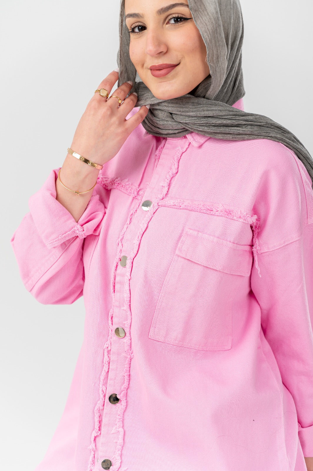 Distressed denim shirt by Akira featuring a casual fit, frayed edges, and classic button-up style, displayed on a plain background.