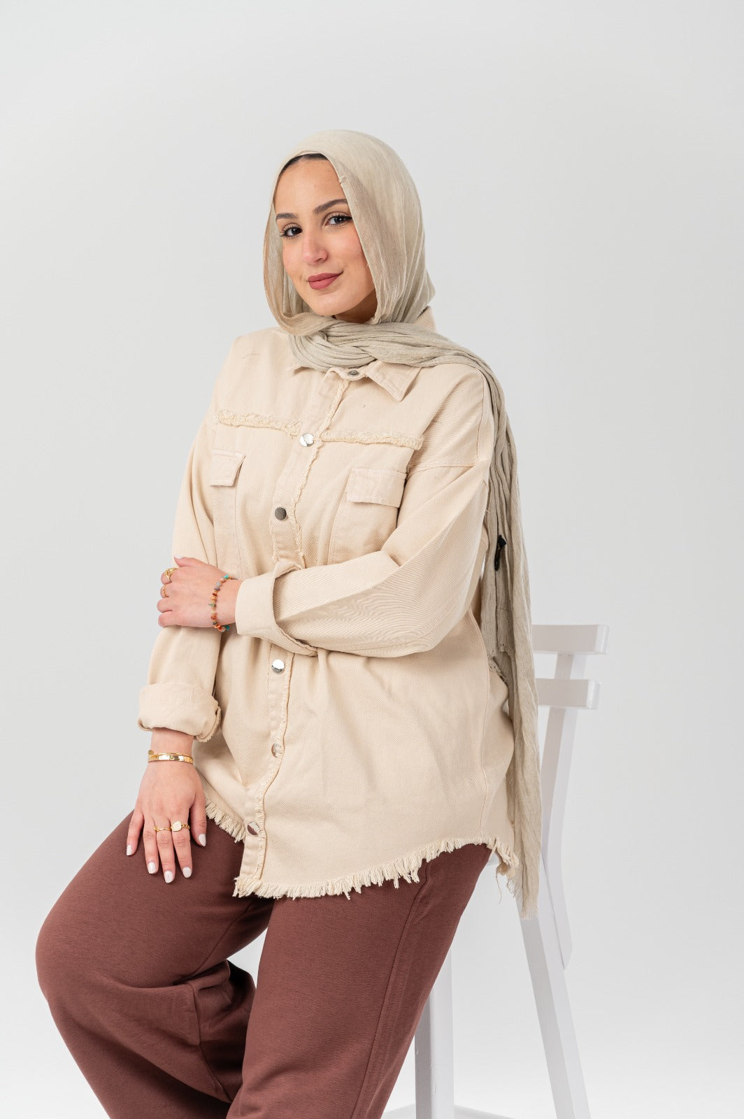 Distressed denim shirt by Akira with a casual fit, featuring ripped details and a classic button-up style.