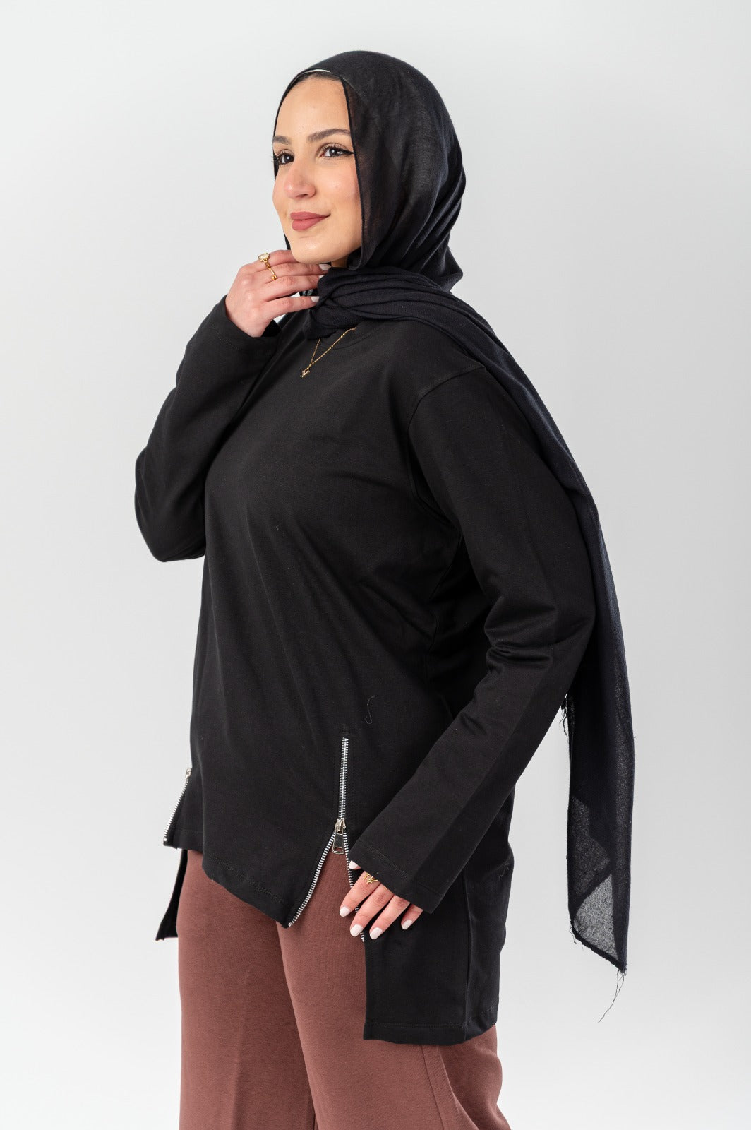 Black Akira side-zip longline T-shirt with a relaxed fit and extended hem, featuring a stylish side zipper detail.