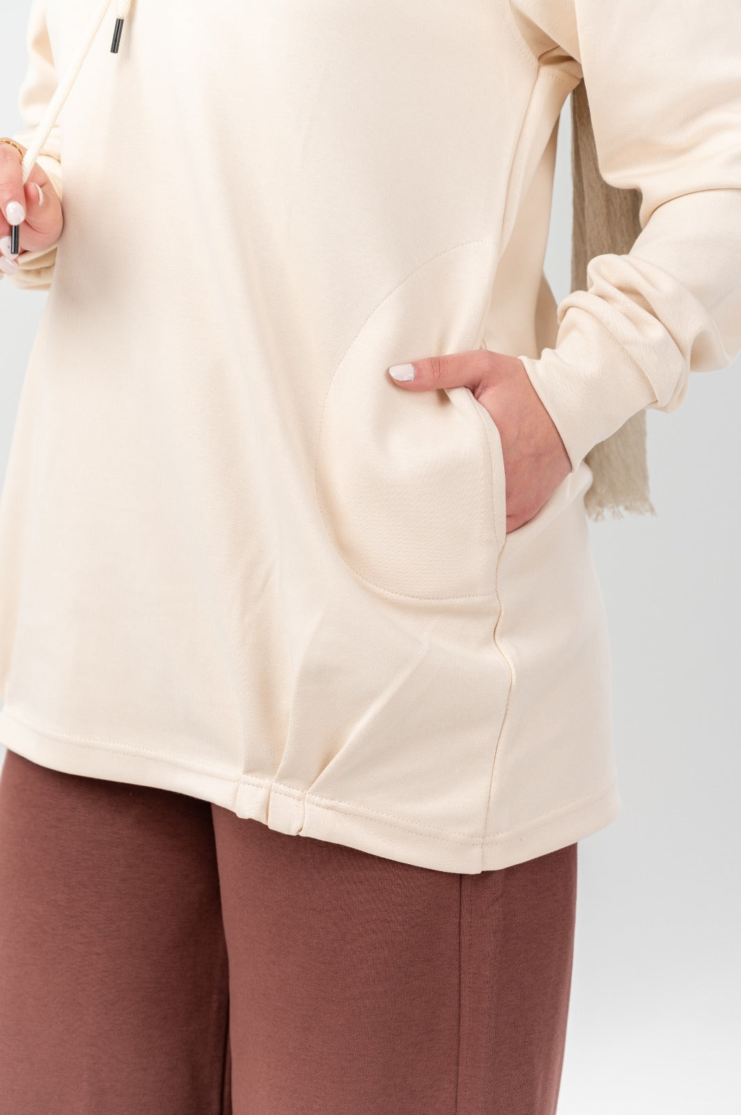 Beige comfort hoodie by Akira, featuring a relaxed fit with soft fabric and a hood, displayed on a neutral background.
